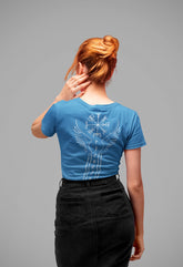 Person wearing a blue t-shirt with a white graphic design on a gray background