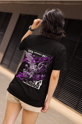 Person wearing a black t-shirt with graphic designs and text, standing indoors.