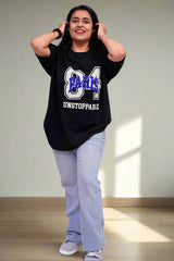 Person wearing a black t-shirt with text and graphics on a blue background