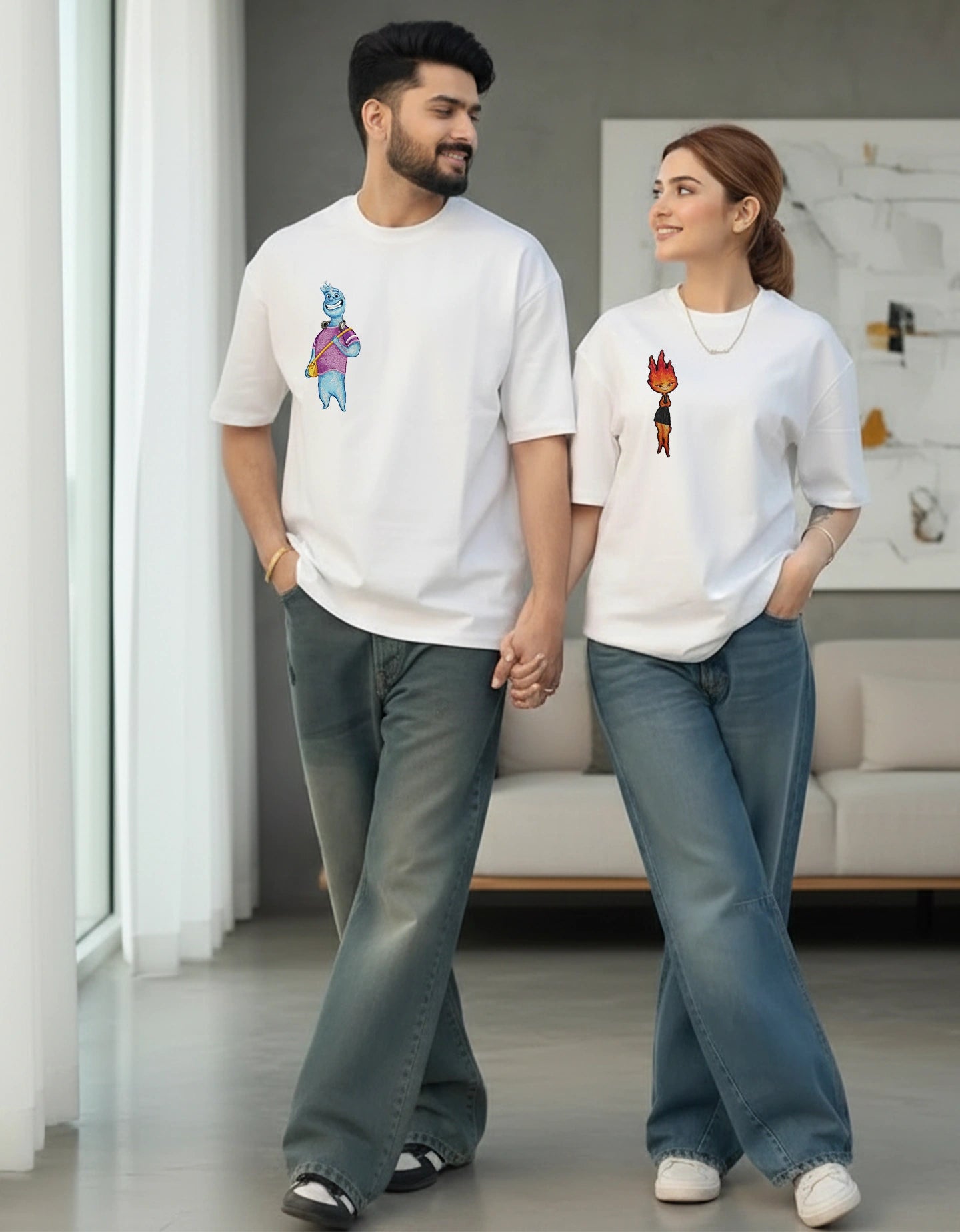 Couple posing in white oversized t-shirts paired with casual denim outfits