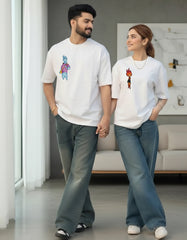 Couple posing in white oversized t-shirts paired with casual denim outfits