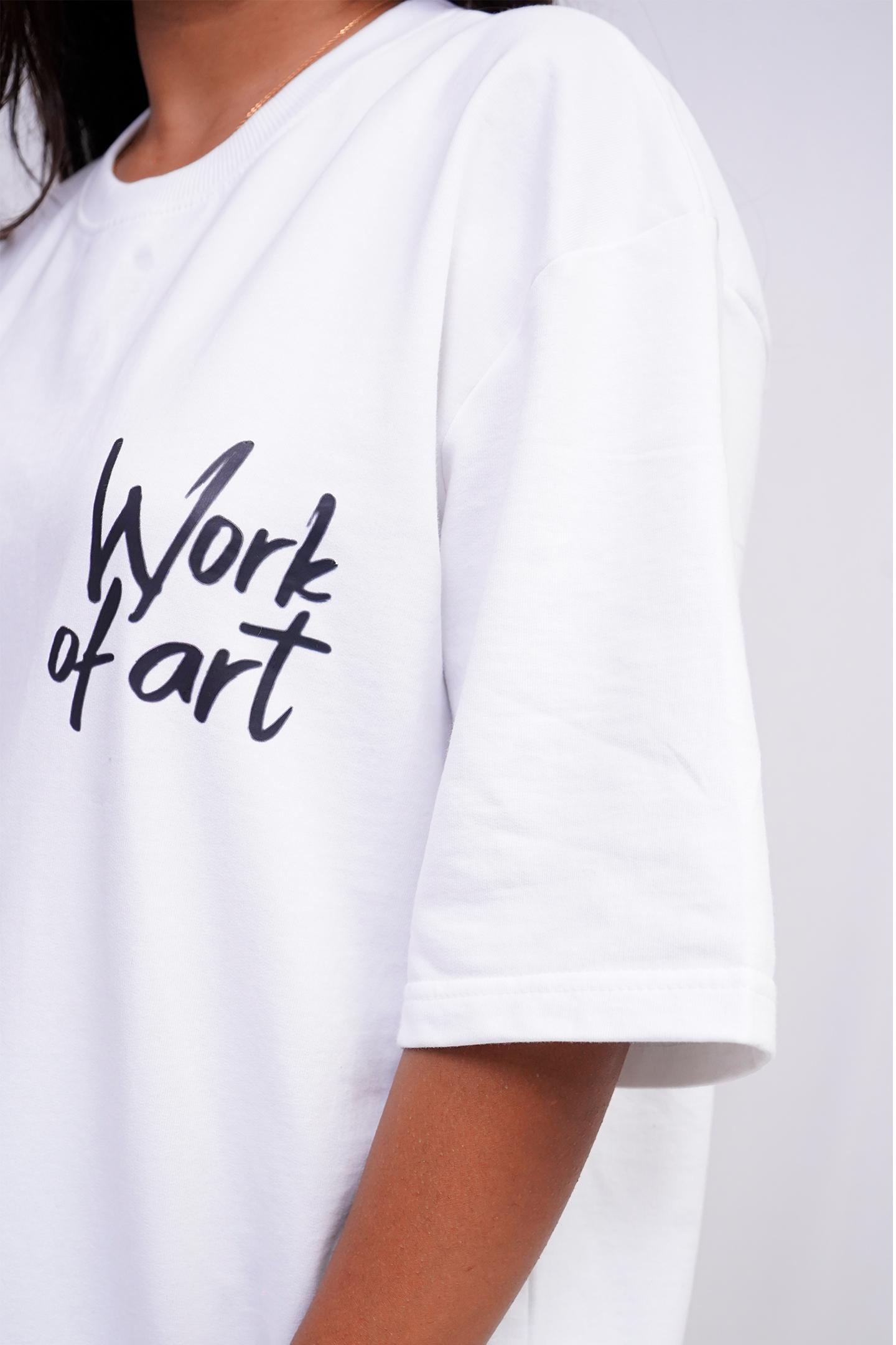 White t-shirt with 'Work of art' text on a white background