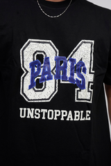 Black t-shirt with '84 Paris Unstoppable' text design on a plain background