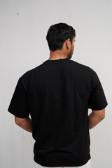 Man wearing a black t-shirt against a plain background