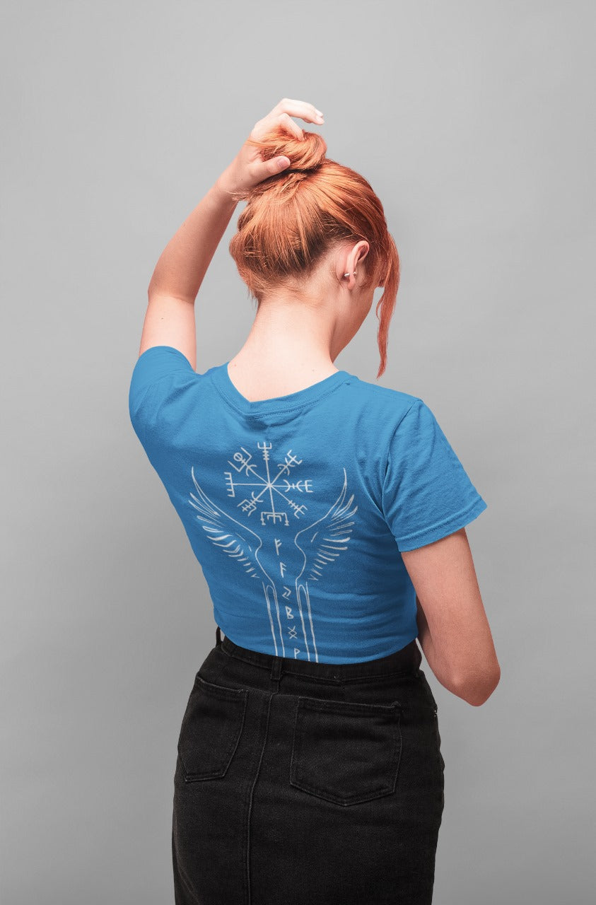 Person wearing a blue t-shirt with a design on the back, standing against a gray background