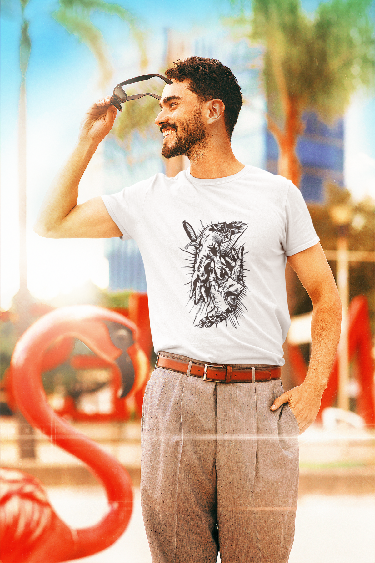 Man wearing a white t-shirt with a graphic design, standing outdoors with colorful background