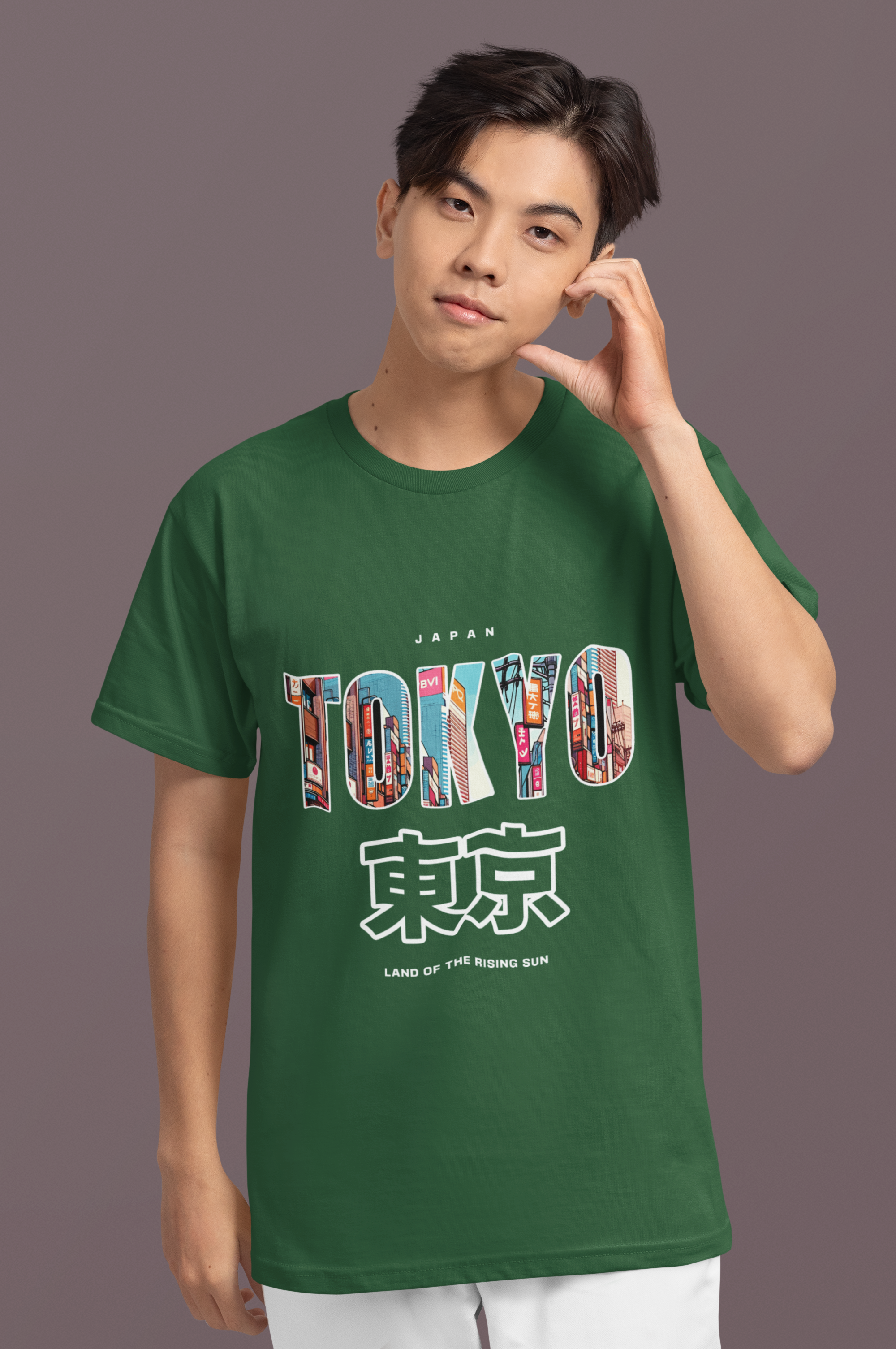 Person wearing a green t-shirt with 'TOKYO' print on a gray background