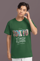 Person wearing a green t-shirt with 'TOKYO' print on a gray background