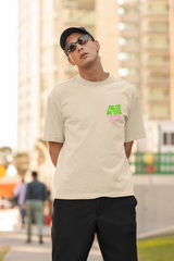 Man wearing a beige t-shirt with a logo, sunglasses, and a cap in an urban setting  Oversized T-Shirt From Kapda Kulture.