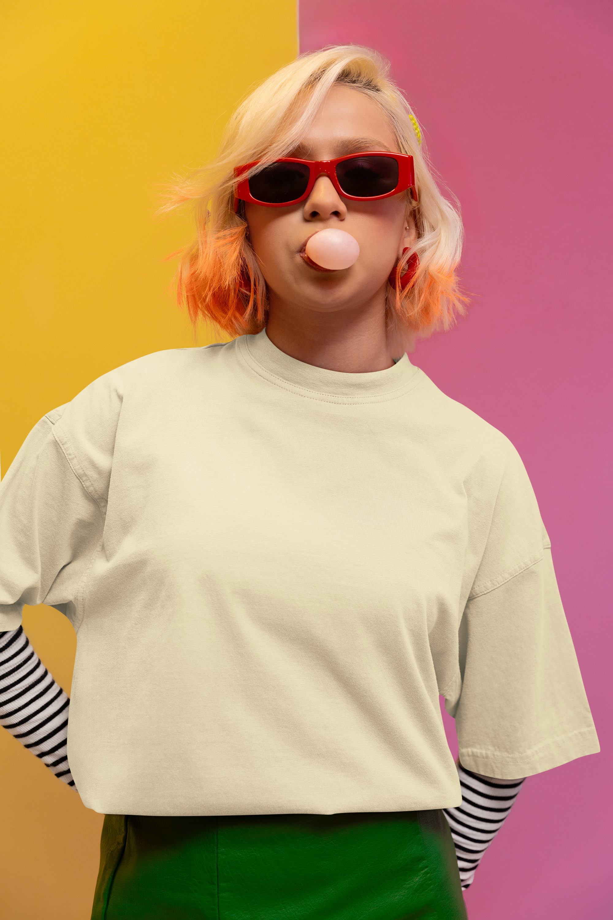 Person with colorful hair blowing a bubble against a multicolored background Oversized T-Shirt From Kapda Kulture.