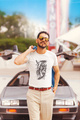Man standing in front of a vintage car wearing a white t-shirt with a graphic design Slim Fit T-Shirt From Kapda Kulture.