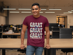 Person wearing a maroon t-shirt with 'GREAT GREAT GREAT ASTRONAUT' text in an office setting