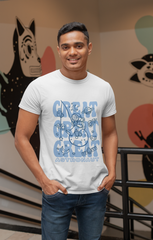 Man wearing a white t-shirt with blue graphic design in front of a colorful wall.