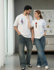 Young couple wearing matching white oversized t-shirts in a lifestyle setting